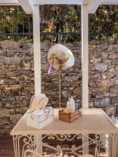 a table with a lamp and a stone wall at Hotel Sant'Andrea in Santa Margherita Ligure