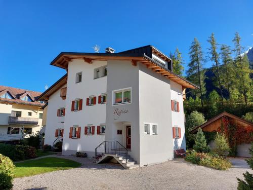 a large white building with a staircase on it at Haus Regina in Sesto