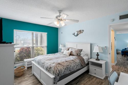a bedroom with a bed and a ceiling fan at #231 E Madeira Beach Yacht Club in St. Pete Beach