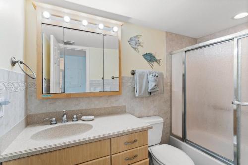 a bathroom with a toilet and a sink and a shower at #231 E Madeira Beach Yacht Club in St Pete Beach