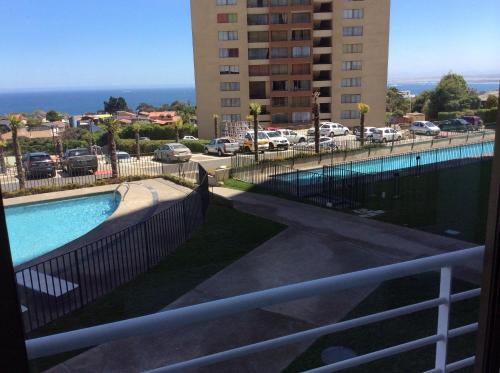 a view of a swimming pool from a balcony of a building at Apartment Concón in Concón