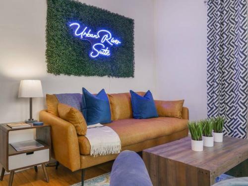 a living room with a couch and a neon sign at MidCentury Mod Suite, Hudson River/Mt Beacon Views in Newburgh