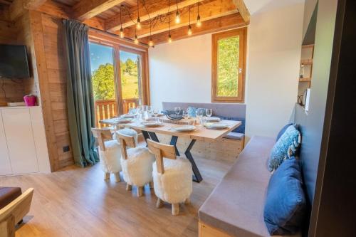 a dining room with a table and chairs at Hauts de Chantemouche 17 in Méribel