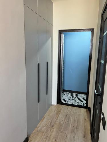 a room with a glass door and a window at Green Plaza - Sunset Room in Aktau