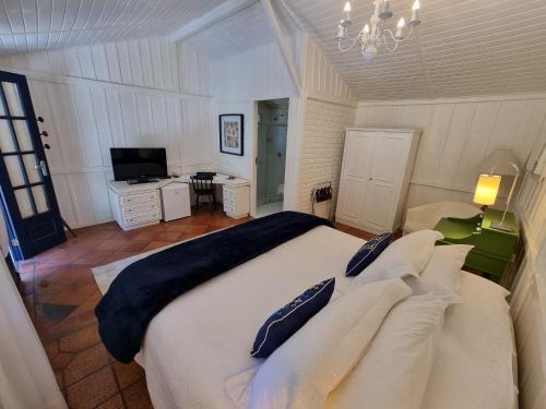 a bedroom with a large bed and a television at Saison Resort & Spa in Itaipava