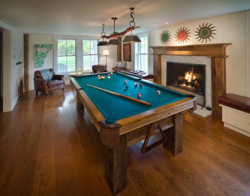 a living room with a pool table and a fireplace at Hill Farm Inn - Manchester in Sunderland