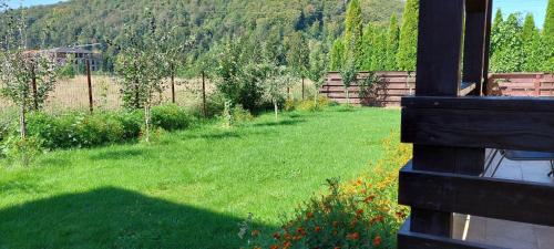 a yard with a field of grass and a fence at Carpen View Residence in Săcele