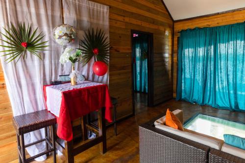 a living room with a table and a couch at Lina Point Belize Overwater Resort in San Pedro