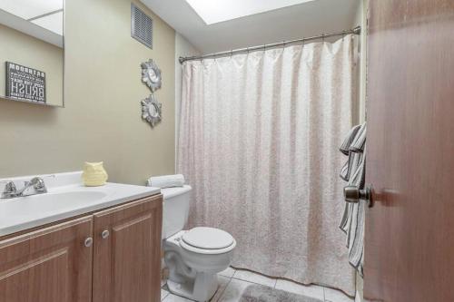 a bathroom with a toilet and a sink and a shower at Glendale Getaway Prime Brandon location in Brandon