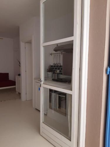 a kitchen with a glass cabinet with a stove at App ALEX, Estoril Beach - Step away from the sea ( Free Wifi) in Sal Rei