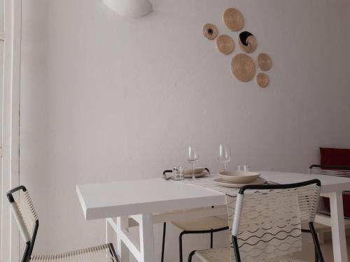 a white dining room with a white table and chairs at App ALEX, Estoril Beach - Step away from the sea ( Free Wifi) in Sal Rei