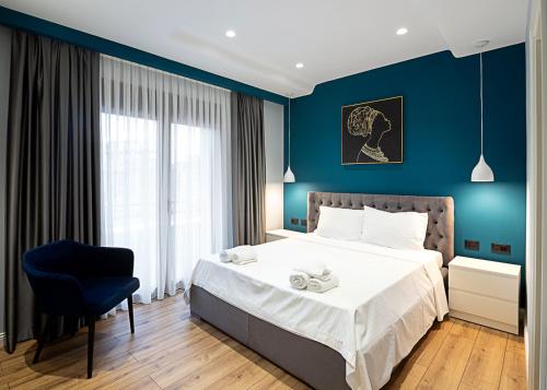 a bedroom with a bed and a blue wall at Paradise Point in Korçë
