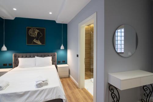 a bedroom with a bed and a mirror at Paradise Point in Korçë