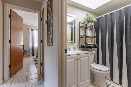 a bathroom with a toilet and a sink and a mirror at Fifties Flat MidCentury flat in heart of Brandon in Brandon