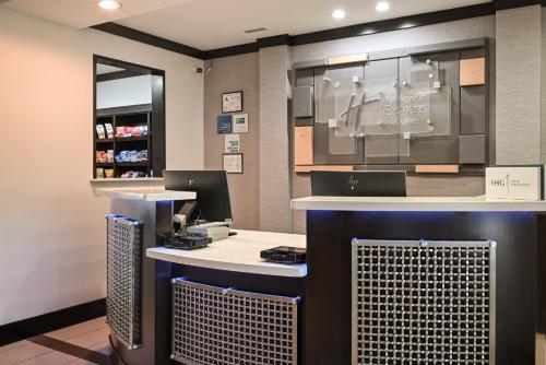 a store with a counter with two computers on it at Holiday Inn Express Charlotte Southeast - Matthews, an IHG Hotel in Charlotte