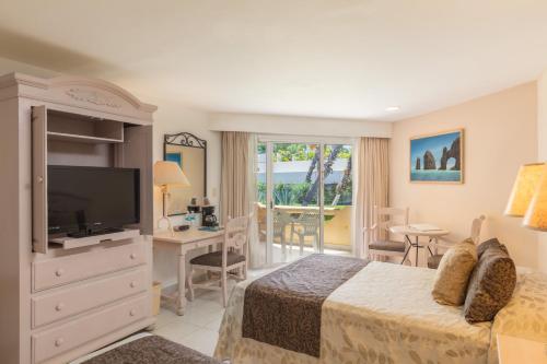 a hotel room with a bed and a television at Posada Real Los Cabos in San José del Cabo