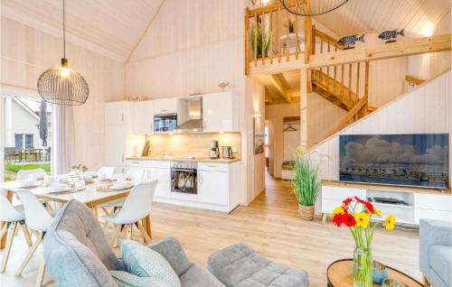 a dining room and kitchen with a table and chairs at Heimathafen in Olpenitz