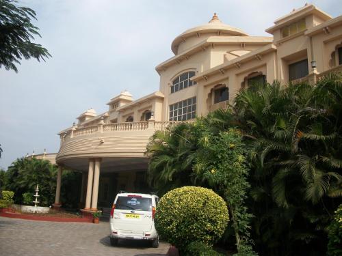 a white van parked in front of a building at Renest Shraddha Inn - Shirdi in Shirdi
