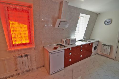 a kitchen with a sink and a microwave at Dragomir Apartments in Cherkasy