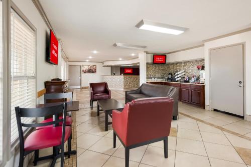 a restaurant with chairs and tables and a bar at Red Roof Inn College Station in College Station