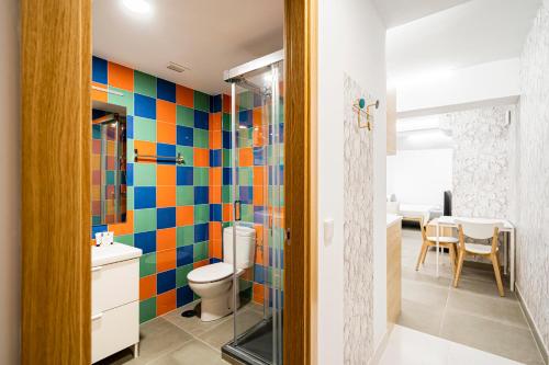 a bathroom with colorful tiles on the wall at dobohomes - Horcajuelo in Madrid