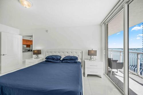 a bedroom with a blue bed and a balcony at Luxurious 1 Bed Apartment in Brickell • Ocean View in Miami