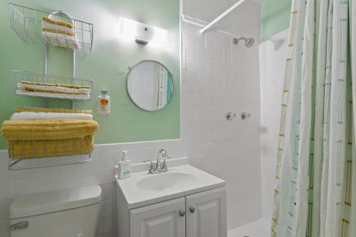 a bathroom with a sink and a mirror and a shower at Deco Drive WATERFRONT 1Bed Apartment on the Bay in Tampa