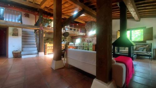 a living room with a large couch in a building at Casa Corazón de piedra en el Río Dulce in Aragosa