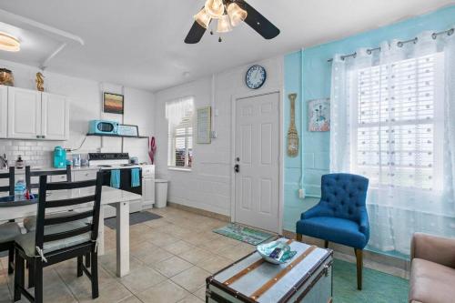 a kitchen with a table and a blue chair at Mermaids Grotto WATERFRONT 1BR Apt with Bay View in Tampa