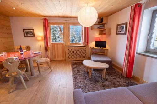 a living room with a table and a couch at Chantemerle 6 in Méribel