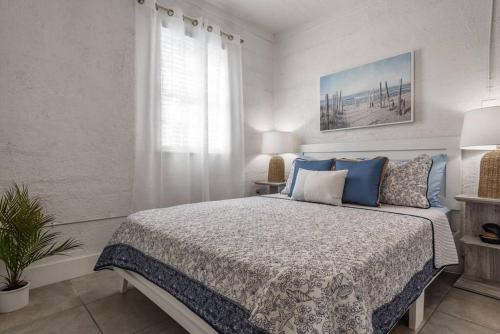 a bedroom with a large bed with blue pillows at The Sea House WATERFRONT Apt by Downtown in Tampa