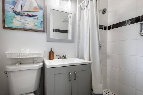 a bathroom with a toilet and a sink and a shower at The Sea House WATERFRONT Apt by Downtown in Tampa