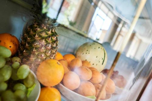 a pile of fruit sitting on top of a table at Hotel A Casa Nostra in Rimini