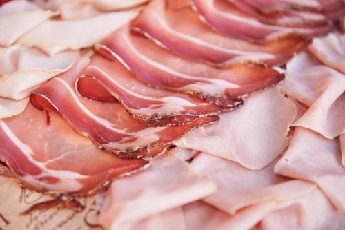 a close up of a plate of food with bacon at Hotel A Casa Nostra in Rimini