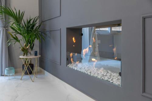 a living room with a fire place in a wall at New & unique apartment - A 5 minutes ferry to capital city of Valletta in Senglea