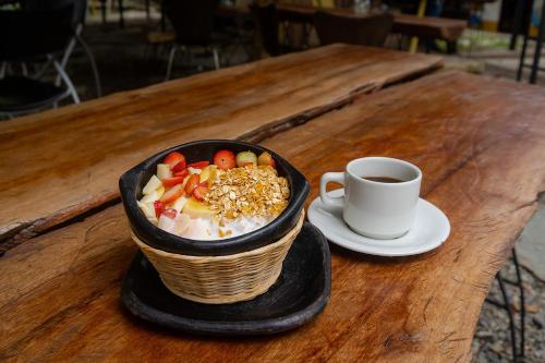 a bowl of food on a table with a cup of coffee at Ayenda Flora Jaguar in Ibagué