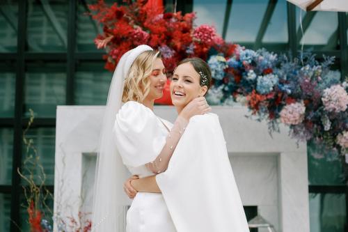 a bride and groom hugging in front of a building at Virgin Hotels New Orleans in New Orleans