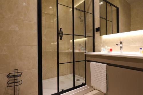 a bathroom with a shower and a sink at Hotel54 Luxury Suite in Sakarya