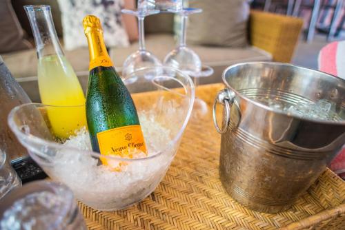 a bottle of champagne sitting in a bucket on a table at Virgin Hotels New Orleans in New Orleans