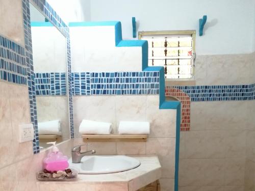 a bathroom with a sink and a mirror at House Jardin Del Caribe in Las Terrenas