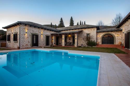 a large swimming pool in front of a house at Patriko Estate in Epirus in Térovon