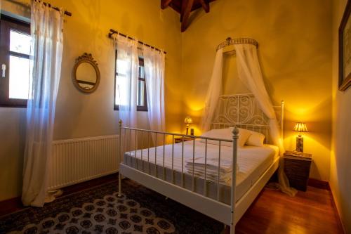 a bedroom with a bed with a canopy at Patriko Estate in Epirus in Térovon