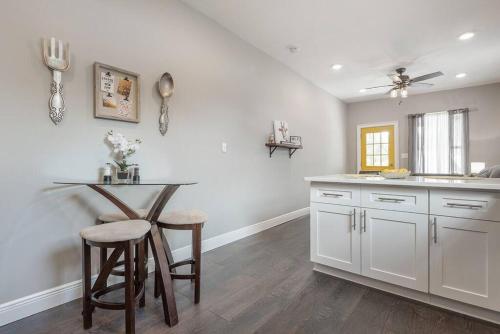a kitchen with a table and chairs and a counter at Gambino Getaway Shotgun style apt in the heart of Ybor City in Tampa