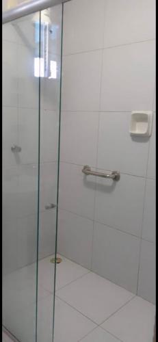 a shower with a glass door in a bathroom at Barra Adventure Pousada in Mataraca