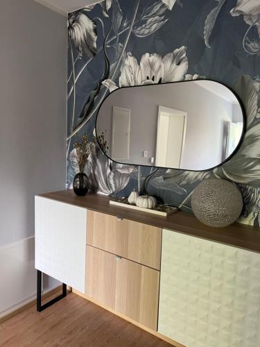 a bathroom with a mirror on top of a dresser at Ferienwohnung Simon in Freudenstadt