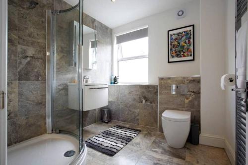 a bathroom with a shower and a toilet and a sink at Park Crescent apartment in York