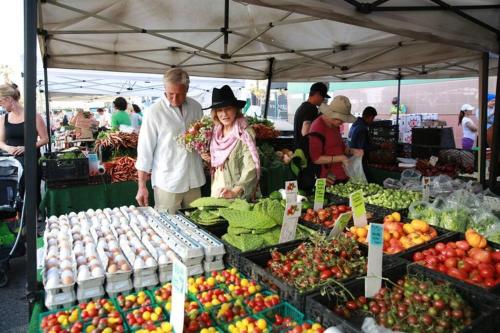 a man and woman standing in a market with fruits and vegetables at The Best Santa Monica Beach Area, Any days,Newly Remodeled in Los Angeles