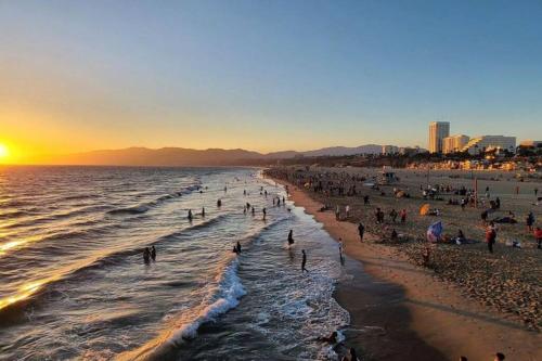 a group of people on the beach at sunset at The Best Santa Monica Beach Area, Any days,Newly Remodeled in Los Angeles