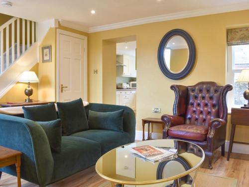 a living room with a couch and a table at 3 The Reading Room Cottages - Uk31802 in Barningham