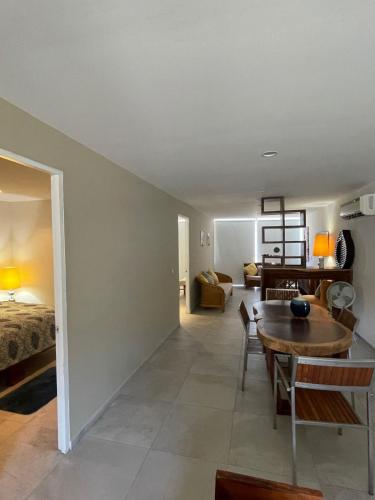 a living room with a table and a bedroom at Playa & Piscina en Punta Gaviota in Tangolunda
